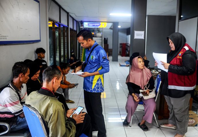 BANYUWANGI, July 3, 2025  -- Family members and relatives wait for news after a ferry capsizing accident at Ketapang Port in Banyuwangi, East Java, Indonesia, July 3, 2025. 