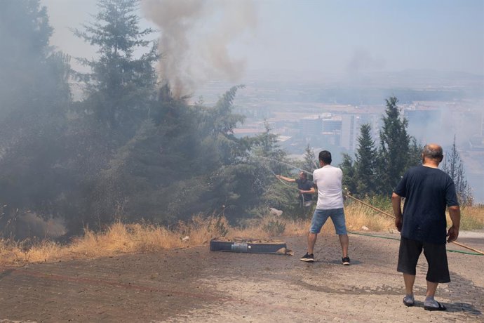 July 2, 2025, Izmir, Turkey: People seen trying to extinguish a fire in Menemen district of Izmir. In Izmir, the western city of Turkey, forest fires have been out of control for days as temperatures and winds rise. Thousands of hectares of land were burn