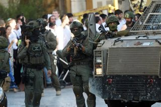 HEBRON, June 29, 2025  -- Members of Israeli forces secure the streets for Israeli settlers in the Old City of Hebron in the southern West Bank, on June 28, 2025.