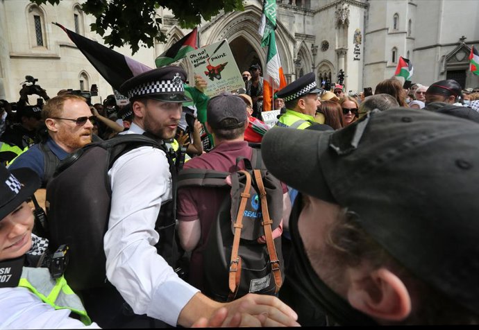 July 4, 2025, London, England, UK: Police surround a pro-Israeli protester that counter demonstrates outside court. Supporters of Palestine Action gather outside the High Court in solidarity with the group as their legal team lodge a challenge (interim re