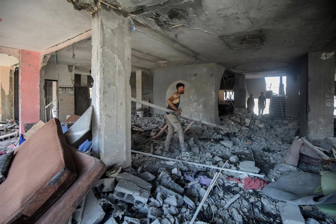 GAZA, July 5, 2025  -- Palestinians inspect a destroyed house after an Israeli airstrike in the al-Shati refugee camp, west of Gaza City, on July 4, 2025.