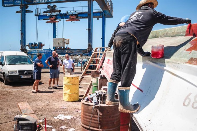 Un pescador realiza labores de mantenimiento de su embarcación en la cofradía de San Miguel de Tajao