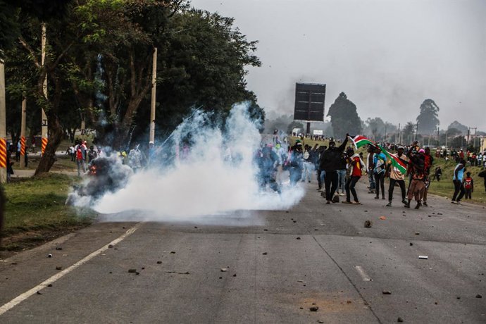 July 7, 2025, Nakuru, Kenya: Protesters wave a Kenyan flag as a teargas canister explodes behind them during the Saba Saba demonstrations. Saba Saba Day (7/7) is commemorated annually on July 7 to mark the 1990 pro-democracy protests that demanded an end 