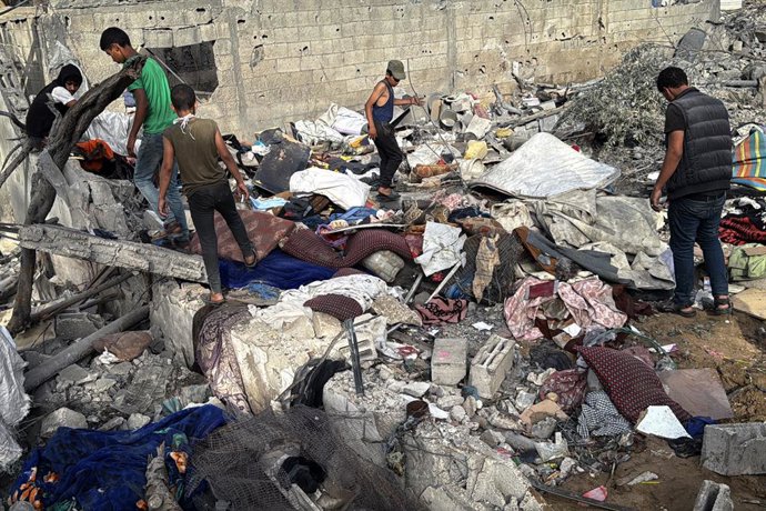 July 1, 2025, Dair El-Balah, Gaza Strip, Palestinian Territory: Palestinians inspect the rubble of the Al-Aimawi family's home, destroyed by Israeli airstrikes in Al-Zawaideh, central Gaza Strip.