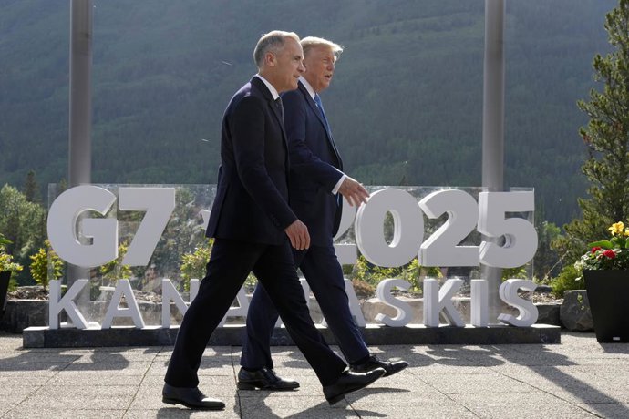 June 16, 2025, Kananaskis, Ab, CANADA: Prime Minister Mark Carney walks with U.S. President Donald Trump before the family photograph during the G7 Summit in Kananaskis, Alta., Monday, June 16, 2025.