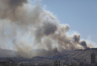 DAMASCUS, July 5, 2025  -- Smoke rises as a result of a fire that erupted near the Syrian al-Shaab presidential palace in Damascus, Syria, July 4, 2025. Unknown fire erupted Friday afternoon in bushes close to the Syrian al-Shaab presidential palace situa