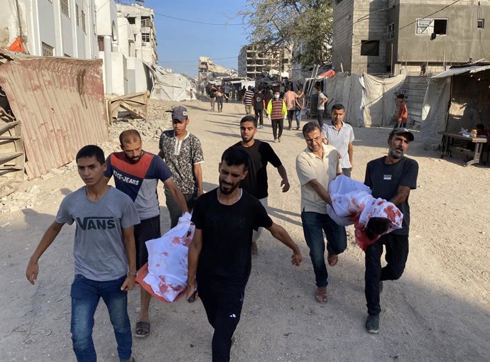 July 12, 2025, Gaza City, Gaza Strip, Palestinian Territory: Mourners carry the bodies of Palestinian children killed in an Israeli strike on Al-Shati refugee camp, according to the Gaza Health Ministry, during a funeral at Al-Shifa Hospital, in Gaza City