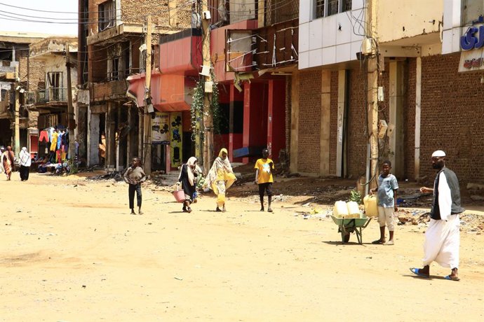 OMDURMAN (SUDAN), July 4, 2025  -- People are seen on a street in Omdurman city, north of Khartoum, Sudan, on July 3, 2025. After more than two years of devastating conflict, Sudan's capital Khartoum is slowly emerging from the ruins of war, inching towar
