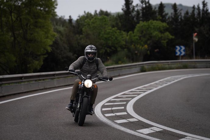 Archivo - Una moto circula por una carretera.