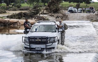 July 8, 2025, Kerrville, Texas, USA: A Wilson County Sheriffâ€s vehicle escorts two  first responders involved in search and rescue across a flooded Center Point River Road just North of Center Point, Texas on July 8, 2025.  Tuesday was the first day wher