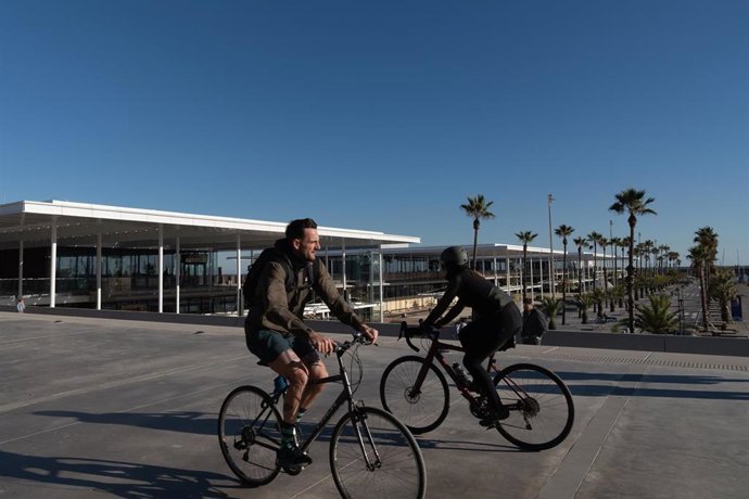 Archivo - Dos personas montan en bicicleta por el Port Olímpic,  en Barcelona, Catalunya (España). 