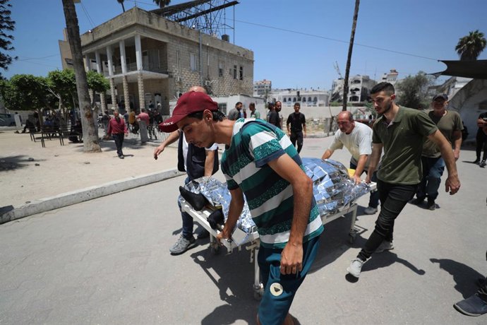 July 17, 2025, Gaza City, Gaza Strip, Palestinian Territory: Christian Palestinian mourners take the body of a loved one for burial from the city's Arab Ahli, also known as Baptist Hospital, following an earlier Israeli strike on the Holy Family Church, i