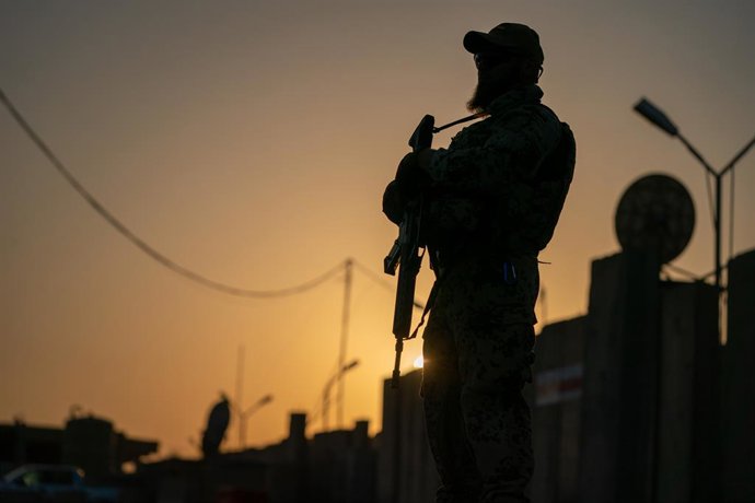 Archivo - 20 August 2019, Iraq, Baghdad: A soldier of the German Armed Forces stands at dusk with his weapon on the verge of the German Defence Minister's visit to the international military camp 'Camp Taji'. Photo: Michael Kappeler/dpa