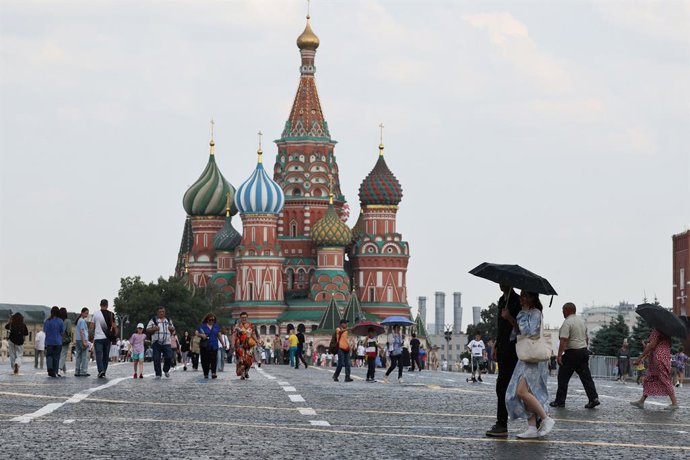 RUSSIA, MOSCOW - JULY 8, 2025: Citizens stroll about Red Square, with St Basil's Cathedral in the background