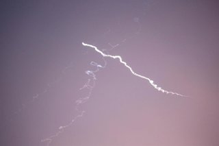 24 June 2025, Palestinian Territories, Nablus: Iranian missiles aimed at targets in Israel pass over the West Bank city of Nablus as Israeli air defense systems attempt to intercept them. Photo: Nasser Ishtayeh/SOPA Images via ZUMA Press Wire/dpa