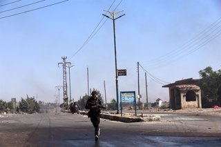 SWEIDA, July 18, 2025  -- A bedouin fighter runs to cross a road in the town of Wolgha, western countryside of Sweida, southern Syria, on July 18, 2025. The Syrian interim authorities on Friday issued a call for restraint amid escalating violence in the s