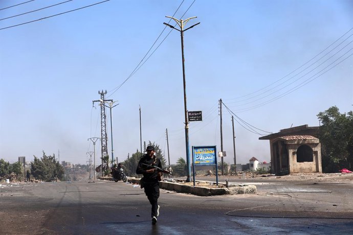 SWEIDA, July 18, 2025  -- A bedouin fighter runs to cross a road in the town of Wolgha, western countryside of Sweida, southern Syria, on July 18, 2025. The Syrian interim authorities on Friday issued a call for restraint amid escalating violence in the s