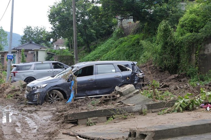 21 July 2025, South Korea, Gapyeong: Damaged cars are left after the region was hit by heavy rainfall. Photo: -/YNA/dpa