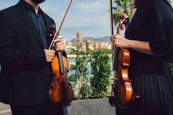 Dos artistas con dos violines.