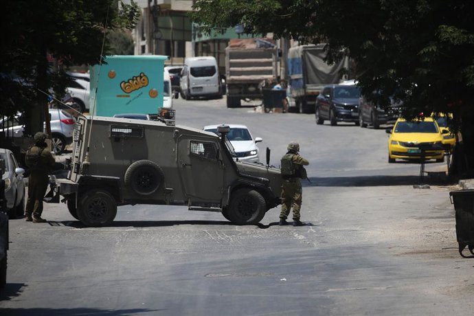 July 23, 2025, Nablus, West Bank, Palestinian Territory: Israeli army forces raid and surround a building in the Ma'ajin area, west of Nablus, in the West Bank, during a military operation in the Ma'ajin area, west of Nablus, July 23, 2025