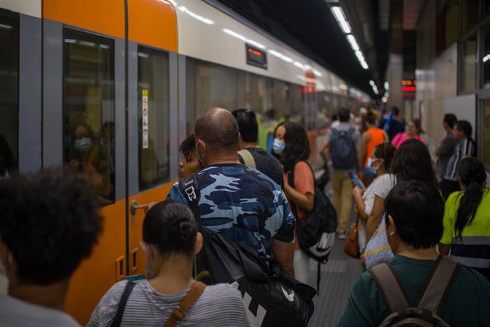 Archivo - Viajeros suben a un tren en uno de los andenes de la estación de Sants, en una imagen de archivo