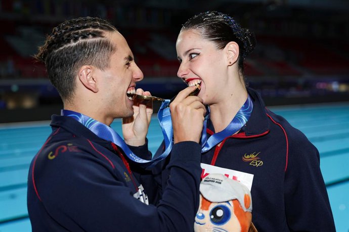 SINGAPORE, July 25, 2025  -- Gold medalists Dennis Gonzalez Boneu/Iris Tio Casas of Spain celebrate after the awarding cerenomy for the mixed duet free final of artistic swimming at the World Aquatics Championships in Singapore, July 25, 2025.