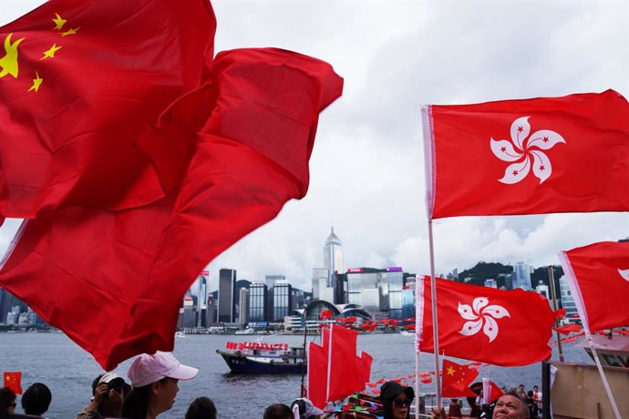 HONG KONG, July 1, 2025  -- Citizens interact with cruising fishing vessels on the Tsim Sha Tsui waterfront in Hong Kong, south China, July 1, 2025. Fishing vessels take part in a cruise held by the Hong Kong Fishermen Consortium to celebrate the 28th ann
