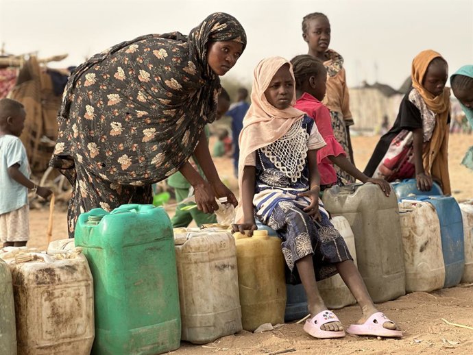 TAWILA(SUDAN), July 16, 2025  -- Photo taken with a mobile phone on April 26, 2025 shows displaced people waiting to collect water from a well in Tawila, North Darfur, western Sudan. Beneath the weary, drought-stricken trees of Tawila, a small town in Nor