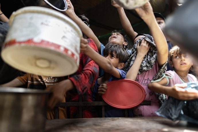 Archivo - May 18, 2025, Gaza, Gaza, Palestine: May 18, 2025, Gaza City Displaced Palestinians go to receive a free meal at a displacement camp in central Gaza City, amid widespread famine due to the closure of crossings for more than two months, the failu