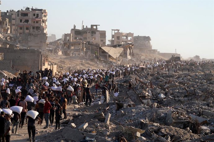 July 30, 2025, Gaza City, Gaza Strip, Palestinian Territory: Palestinians, driven to the brink of starvation under Israeli army's attacks and blockade, gather at an aid distribution point in Gaza Zikim Corridor to access a limited supply of flour in Gaza 