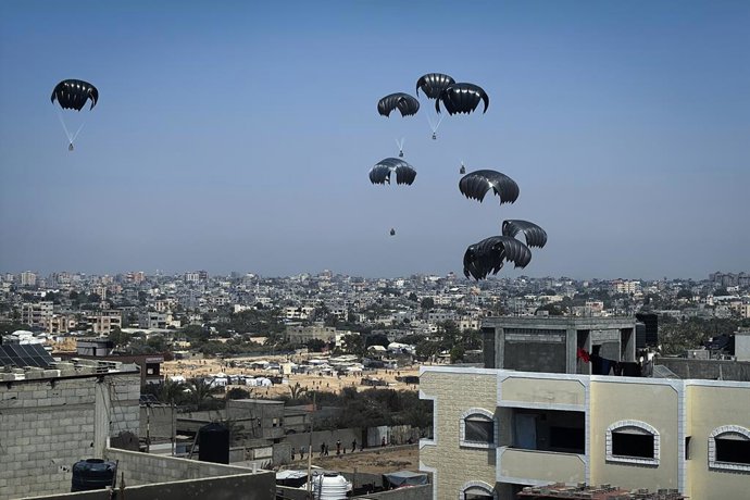 July 28, 2025, Dair El-Balah, Gaza Strip, Palestinian Territory: Humanitarian aid supplies are airdropped by military cargo planes over the western part of Deir al-Balah, in Al-Zawayda, Gaza. The aid parcels were collected from the ground by civilians gat