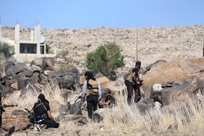 SWEIDA, July 18, 2025  -- Tribal fighters take positions during clashes in the town of Wolgha, western countryside of Sweida, southern Syria, on July 18, 2025. The Syrian interim authorities on Friday issued a call for restraint amid escalating violence i