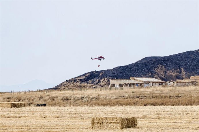 Archivo - Un helicóptero trabaja en la zona quemada durante un incendio forestal, en el Cerro del Viso, a 26 de junio de 2024, en Alcalá de Henares, Madrid (España). 