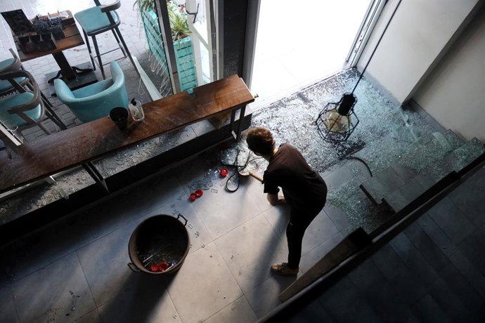 July 22, 2025, Odessa, Ukraine: A woman cleans up broken glass in a gym after a drone attack in the Kiev district. As a result of the attack, more than 10 cars were burned down near a residential complex in Kiev district, a grocery store and a sports hall