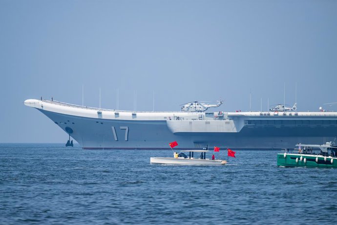 HONG KONG, July 7, 2025  -- Local people taking ferries see off the Chinese People's Liberation Army (PLA) Navy fleet in Hong Kong, south China, July 7, 2025. A fleet of the Chinese People's Liberation Army (PLA) Navy, led by the aircraft carrier Shandong