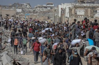 August 5, 2025, Gaza City, Gaza Strip, Palestinian Territory: Palestinians carry aid supplies that entered Gaza through Israel, in Beit Lahia in the northern Gaza Strip, on August 5, 2025