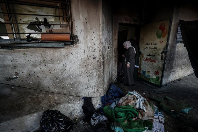 July 25, 2025, Gaza City, Gaza Strip, Palestinian Territory: Palestinians gather at the site of an Israeli strike on a school sheltering displaced people, in Gaza City, July 25, 2025