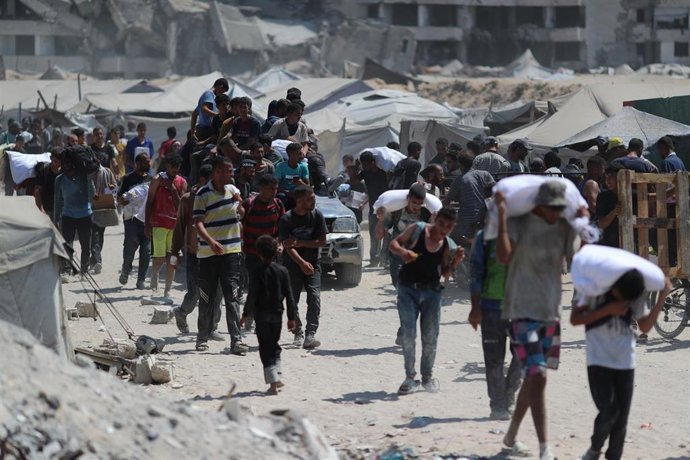 07 August 2025, Palestinian Territories, Gaza City: Palestinians carry aid supplies which they received from the U.S.-backed Gaza Humanitarian Foundation (GHF). Photo: Omar Ashtawy/APA Images via ZUMA Press Wire/dpa