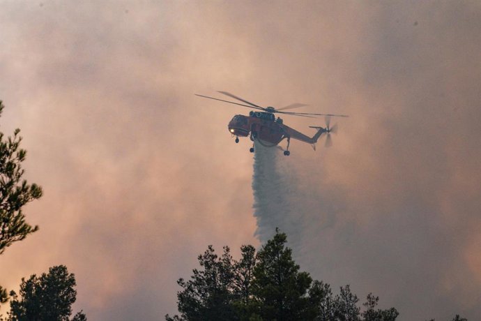 09 July 2025, Greece, Asprochori: A firefighting helicopter is operating during the wildfire in Asprochori, Oropos, Attica. Photo: Giorgos Arapekos/ZUMA Press Wire/dpa