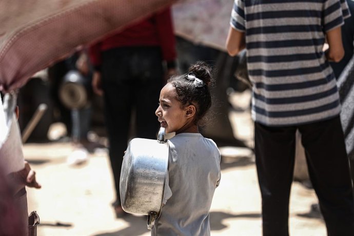 June 1, 2025, Gaza City, Gaza Strip, Palestinian Territory: Displaced Palestinians including women and children wait to receive food distributed by aid organizations in Gaza City, Gaza on June 01, 2025. The situation highlights the growing desperation and