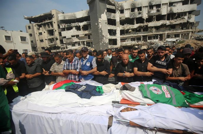Mourners carry the body of Al Jazeera correspondent Anas al-Sharif, who was killed alongside other journalists in an overnight Israeli strike on their tent in Gaza City, during his funeral in Gaza City on August 11, 2025.