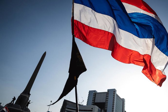 August 2, 2025, Bangkok, Thailand: A large Thai flag waves in the air as the sun sets over Victory Monument during a political rally. Protesters rallied at Bangkokâ€s Victory Monument calling for Prime Minister Paetongtarn Shinawatraâ€s resignation, citin
