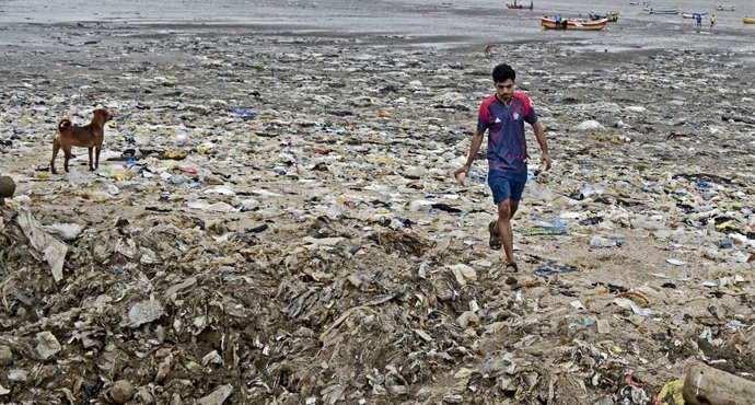 August 8, 2025, Mumbai, Maharashtra, India: A man walks along a beach littered with plastic waste in Mumbai. Pollution along Indian coastline remains a major environmental concern, impacting marine life and the livelihoods of coastal communities.