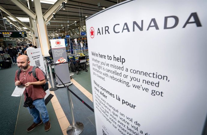 August 16, 2025, Bc, CANADA: A man waits at the Vancouver International Airport in Richmond, B.C., Saturday, Aug. 16, 2025. The union representing more than 10,000 Air Canada flight attendants says its members have walked off the job after it was unable t
