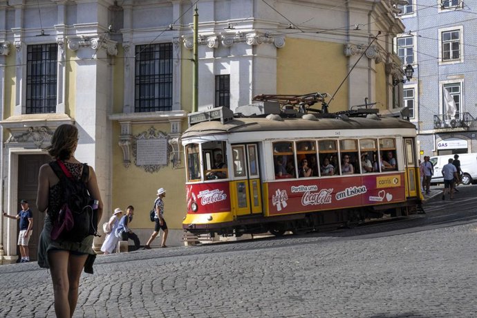 August 5, 2025, Lisbon, Portugal: A tram is seen traveling along one of the streets in the GraĂa district of Lisbon. This summer, Portugal is dealing with really high temps, with thermometers going way above normal and putting urban and rural areas, as w