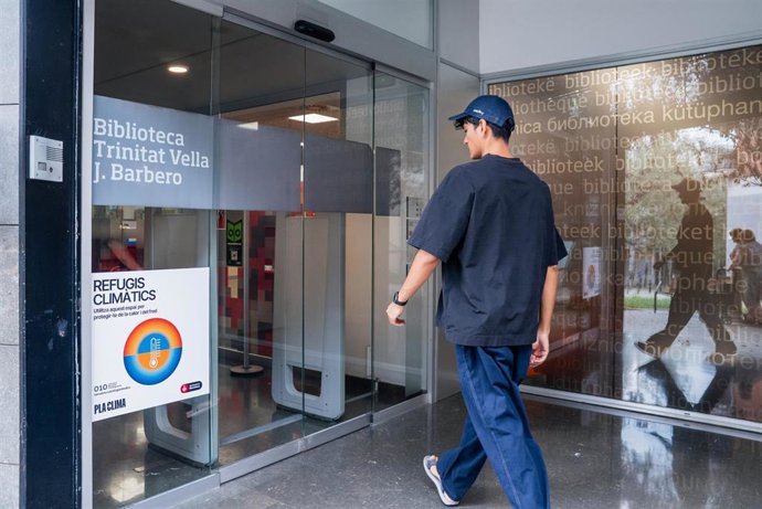 Joven entrando en un refugio climático de Barcelona en el barrio de Trinitat Vella de Barcelona