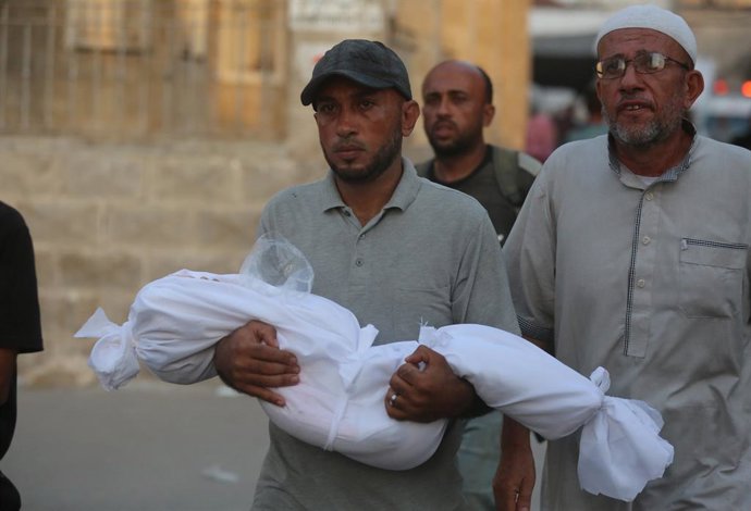 15 de agosto de 2025, Cidade de Gaza, Faixa de Gaza, Território Palestino: Pessoas fazem orações fúnebres depois que os corpos de palestinos, incluindo crianças que perderam a vida, são levados ao Hospital Al-Ahly para uma cerimônia fúnebre após o ataque 