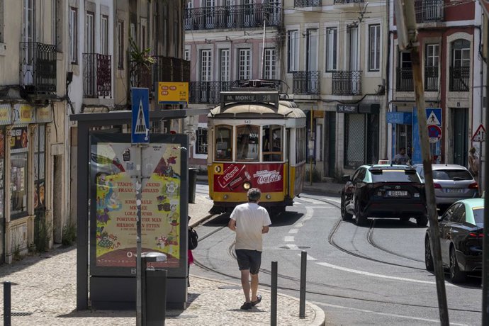 August 5, 2025, Lisbon, Portugal: A tram is seen traveling along one of the streets in the GraĂa district of Lisbon. This summer, Portugal is dealing with really high temps, with thermometers going way above normal and putting urban and rural areas, as w