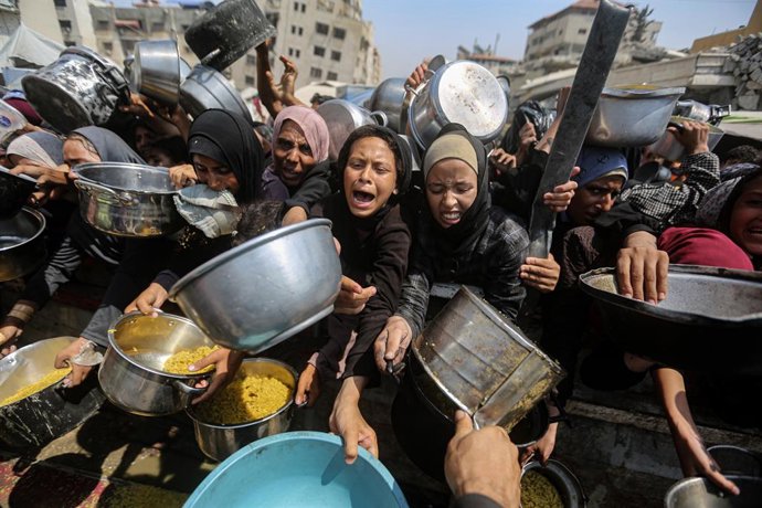 Imagem de arquivo de pessoas desabrigadas em Gaza esperando para receber alimentos.