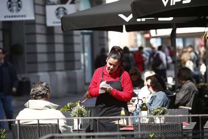 Archivo - Una camarera atiende a un cliente en un restaurante. Imagen de archivo.